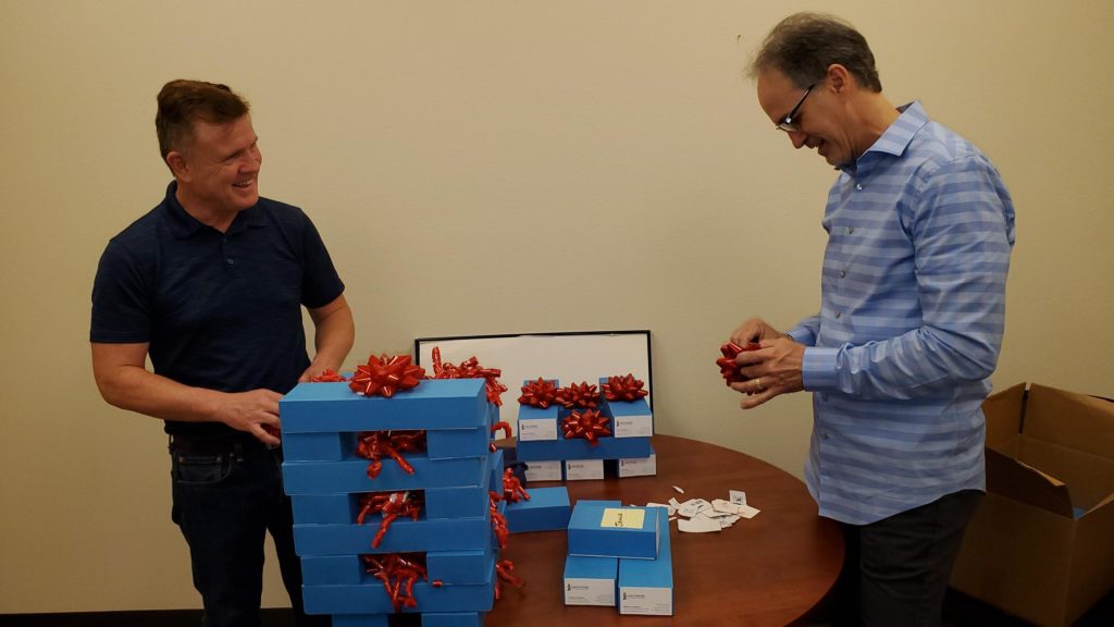 Managers packaging boxes of new business cards to present to staff Click to Enlarge